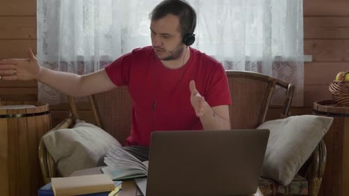 Man Explains Via Laptop During Video Conference