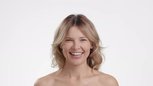 Blonde Woman Smiling Positively in a Studio Close-up