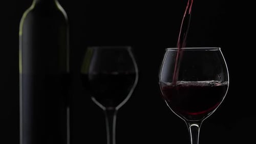 Pouring Dark Red Wine into a Glass