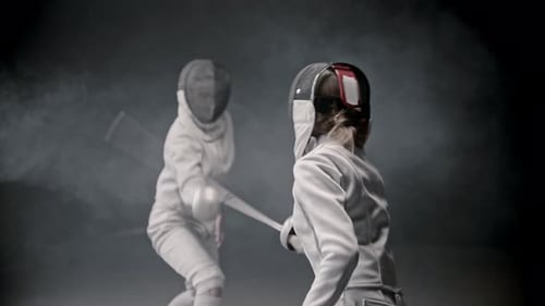 Fencing Training - Two Young Woman Having a Duel Between Each Other