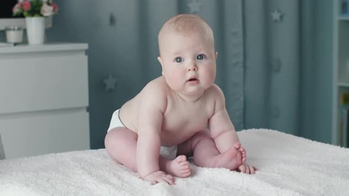 Adorable Infant Sitting in White Nursery