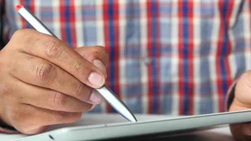 Man's Hand Working on Digital Tablet on Office Desk