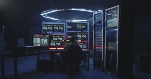 Hacker Using Computer with Multiple Monitors