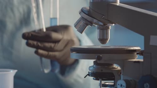 Laboratory Microscope and Test Tubes in Medical Research