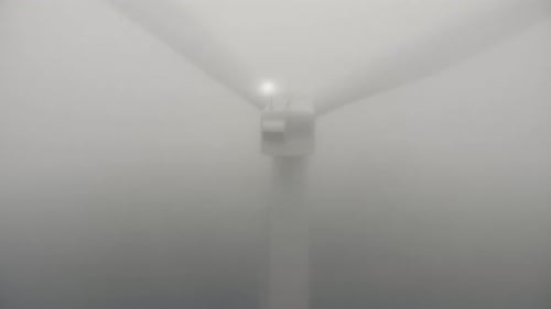 Wind Turbine Rotating in Heavy White Fog