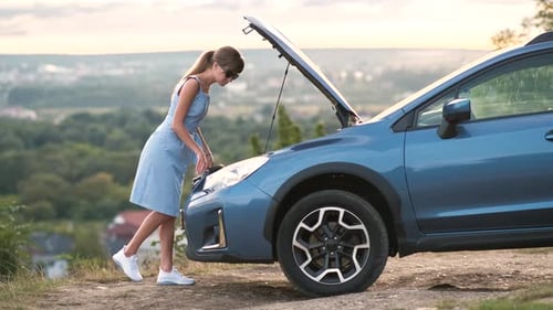 Young Woman Driver Standing Near a Broken Car with Open Hood Having Trouble with Her Vehicle