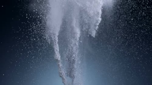 Explosion of White Powder on Blue Backdrop