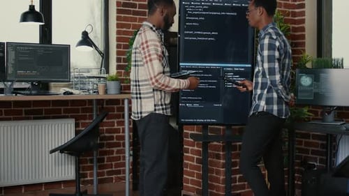 Team of Software Engineers Leaving After Analyzing Source Code on Wall Screen Tv Comparing Errors