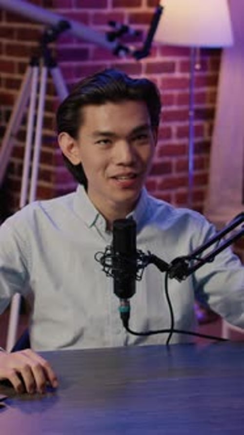 Young Adult at Microphone in Podcast Studio