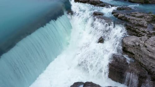 Waterfall and cascade on a mountain river. Powerful stream of water and natural resources