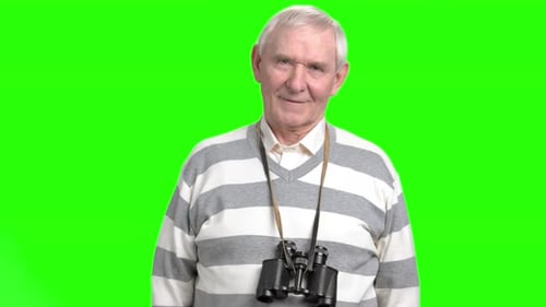 Smiling Senior Man with Binoculars on Green Screen