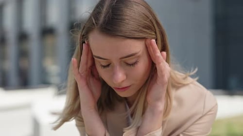 Business Woman Massaging Temples Due to Headache