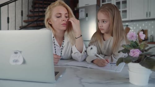 Mother and Daughter Do Homework Together at Home