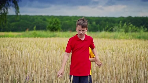 Children Walking Together Through Golden Wheat Field