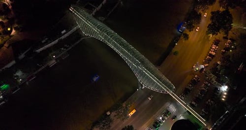 Night aerial view of Bridge of Peace and beautiful cityscape in the center of Tbilisi, Georgia 2022