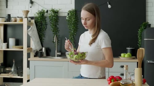 Young Woman Enjoying Healthy Salad at Home