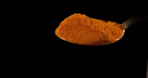 Turmeric, curcuma longa, Powder falling against Black Background, Indian Spice, Slow Motion 4K