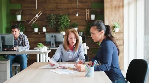 Team Discussing Data at Office Workspace