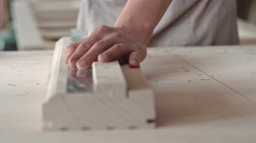 Craftsman Measures Wood in Workshop