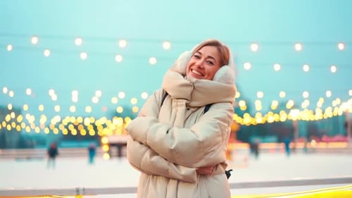 Woman Frozen on Winter Street Hugging Himself Dressed Warm Winter Clothes and Earmuffs Standing