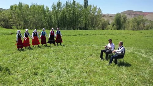 Young Women Traditionally Dancing In Traditional Clothes And Musicians In Village