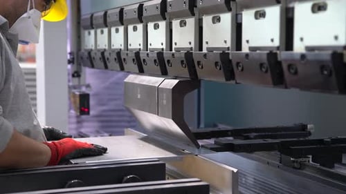 Industrial Worker Shaping Metal with Hydraulic Press