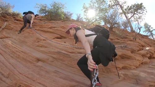 Two girls climbing the Angels Landing hike in Zion National Park, Utah, USA