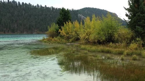 Slowly flying over Cliff Lake in Montana viewing colors changing on the leaves