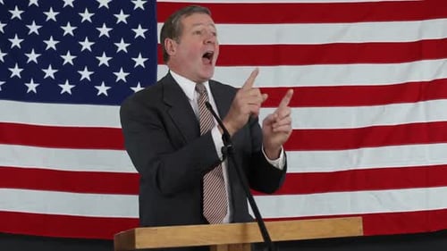 Man Giving Speech with American Flag Background