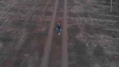Woman Runs Down a Dirt Path in the Country