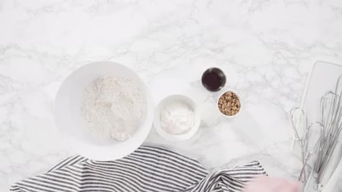 Time lapse. Flat lay. Step by step. Ingredients to bake cranberry muffins on a marble kitchen