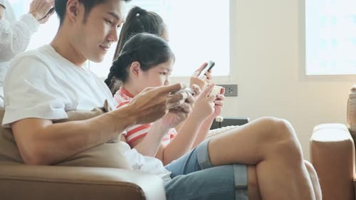 Family Relaxing at Home with Mobile Phones