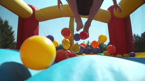 Boy bouncing in inflatable play house, super slow motion