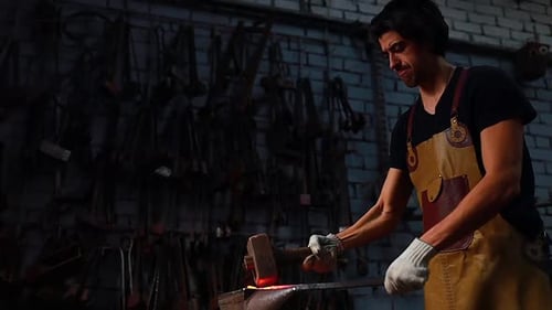 Slow Motion Video of Italian Brunette Man Blacksmith Working in the Workshop