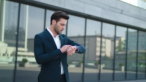 Closeup Man Standing Near Business Building. Businessman Waiting in Suit Outdoor