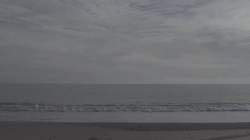 A young woman running on the beach.