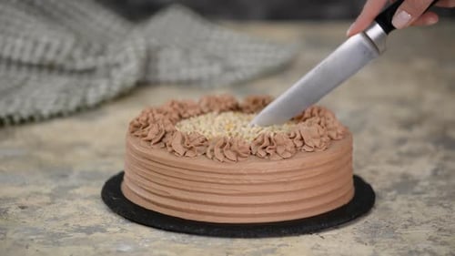 Chocolate Cake Being Sliced with a Knife