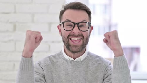 Man Cheering with Excitement and Success Indoors