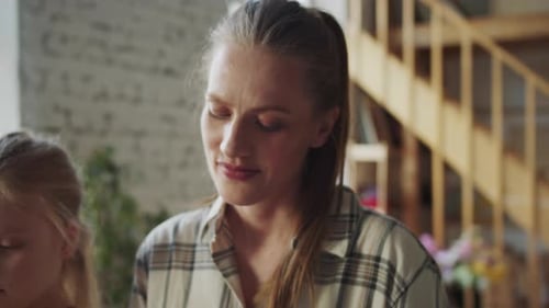Child Learns Piano with Plaid-Clad Adult