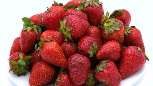 Strawberries rotating on a white background. Strawberry ripe season