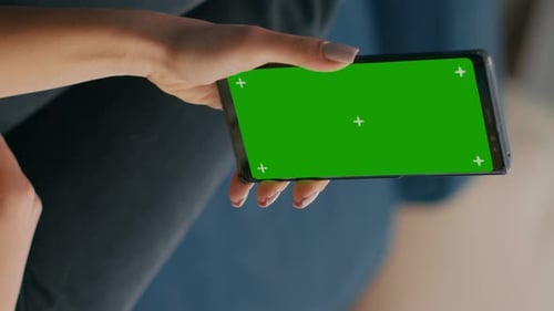 Vertical Video Freelancer Holding in Vertical Mode Smartphone with Mock Up Green Screen Chroma Key