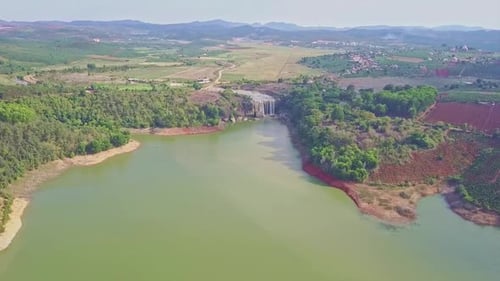 Drone Moves Along River To Waterfall Foot Against Landscape
