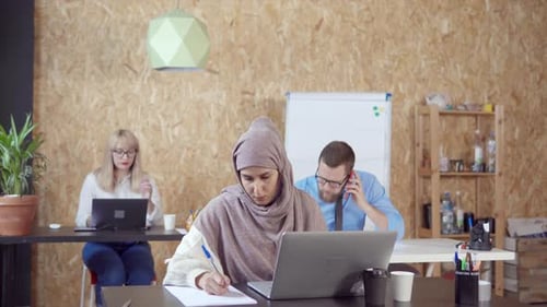 Three People Working at Pc in Office.