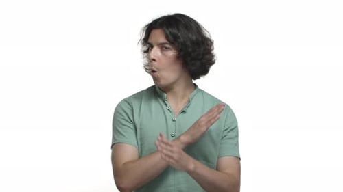 Man Showing Disapproval with Hand Gestures on White