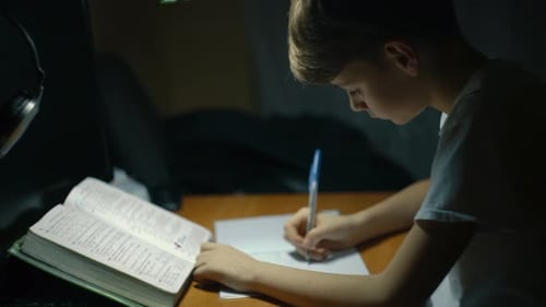 Boy Studying and Doing Homework at Night