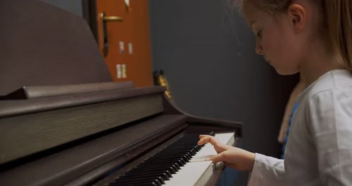 Girl Playing Piano in Her Home