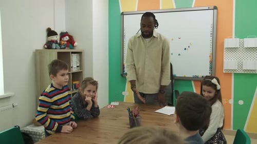 Teacher Instructing Elementary School Children in Classroom