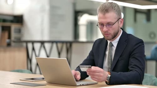 Online Payment Success on Laptop for Businessman in Office