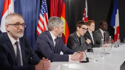 People at Press Conference with International Flags