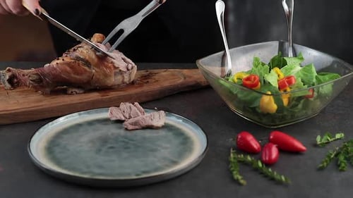 Woman cutting roasted turkey leg